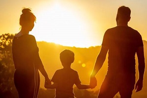 A family watching the sun rise.